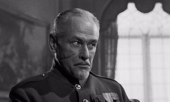 Movie still from “Paths of Glory” (1957), directed by Stanley Kubrick – An older man in a military uniform looking at the camera; Close Up shot, Low angle