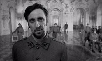 Movie still from “Paths of Glory” (1957), directed by Stanley Kubrick – A black and white photo of a man in a military uniform; Close Up shot, Low angle