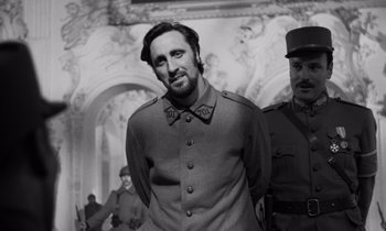 Movie still from “Paths of Glory” (1957), directed by Stanley Kubrick – A black and white photo of a man in a military uniform; Medium shot, Low angle
