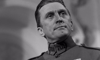 Movie still from “Paths of Glory” (1957), directed by Stanley Kubrick – Black and white photograph of a man in military garb; Close Up shot, Low angle