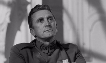 Movie still from “Paths of Glory” (1957), directed by Stanley Kubrick – Black and white photograph of a man in military uniform; Close Up shot, Low angle