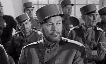 Movie still from “Paths of Glory” (1957), directed by Stanley Kubrick – A black and white photo of a man in a military uniform; Close Up shot, Over the shoulder angle
