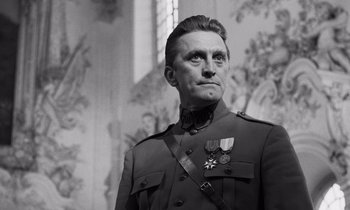 Movie still from “Paths of Glory” (1957), directed by Stanley Kubrick – A man in a military uniform with a medal around his neck; Close Up shot, Low angle