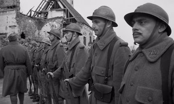 Movie still from “Paths of Glory” (1957), directed by Stanley Kubrick – A black and white photo of a group of men in uniform; Medium shot, Low angle