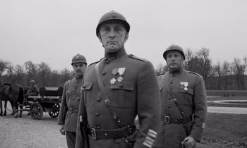 Movie still from “Paths of Glory” (1957), directed by Stanley Kubrick – A group of men standing next to each other wearing military uniforms; Medium shot, Low angle