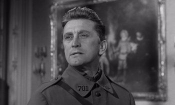 Movie still from “Paths of Glory” (1957), directed by Stanley Kubrick – A man in a military uniform looking to his left; Close Up shot, Low angle