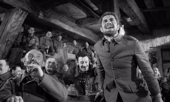 Movie still from “Paths of Glory” (1957), directed by Stanley Kubrick – A black and white photo of a group of men in military uniforms; Wide shot, Low angle