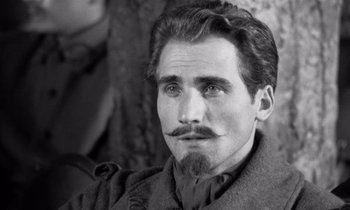 Movie still from “Paths of Glory” (1957), directed by Stanley Kubrick – Black and white photograph of a man with a mustache; Close Up shot, Over the shoulder angle