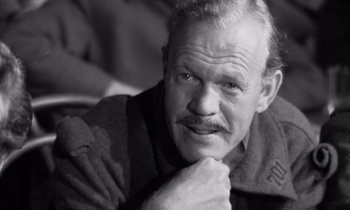 Movie still from “Paths of Glory” (1957), directed by Stanley Kubrick – An older man with a beard and a mustache; Close Up shot, Over the shoulder angle