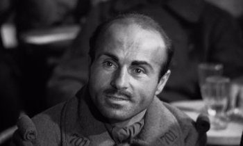 Movie still from “Paths of Glory” (1957), directed by Stanley Kubrick – Black and white photograph of a man with a mustache; Close Up shot, High angle