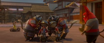 Movie still from “Paws of Fury: The Legend of Hank” (2022), directed by Chris Bailey – A group of people standing next to each other on the ground; Wide shot, High angle