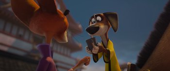 Movie still from “Paws of Fury: The Legend of Hank” (2022), directed by Chris Bailey – A dog holding a cell phone in front of a person; Close Up shot, Over the shoulder angle