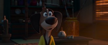 Movie still from “Paws of Fury: The Legend of Hank” (2022), directed by Chris Bailey – A cartoon dog wearing a yellow shirt and standing in front of a table; Close Up shot, Over the shoulder angle