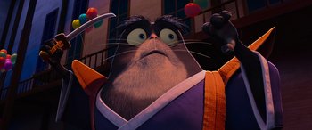 Movie still from “Paws of Fury: The Legend of Hank” (2022), directed by Chris Bailey – A cat wearing a kimono is looking up at the camera; Close Up shot, Low angle