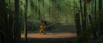 Movie still from “Paws of Fury: The Legend of Hank” (2022), directed by Chris Bailey – A monkey holding a stick in the middle of a forest; Extreme Wide shot, Low angle