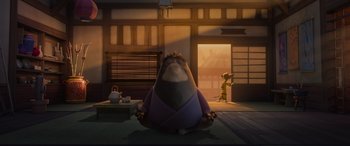 Movie still from “Paws of Fury: The Legend of Hank” (2022), directed by Chris Bailey – An image of an animated character sitting on the floor in front of a door; Wide shot, Low angle