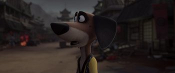 Movie still from “Paws of Fury: The Legend of Hank” (2022), directed by Chris Bailey – A cartoon dog with long hair and a yellow shirt; Close Up shot, High angle