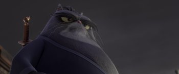 Movie still from “Paws of Fury: The Legend of Hank” (2022), directed by Chris Bailey – A cat's face with a dark background; Close Up shot, Low angle