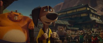 Movie still from “Paws of Fury: The Legend of Hank” (2022), directed by Chris Bailey – A dog wearing a robe standing in front of a group of cats; Close Up shot, Low angle