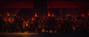 Movie still from “Paws of Fury: The Legend of Hank” (2022), directed by Chris Bailey – A group of people standing next to each other in front of fire; Wide shot, Low angle