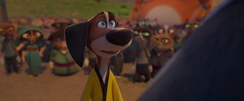 Movie still from “Paws of Fury: The Legend of Hank” (2022), directed by Chris Bailey – A group of people and a dog in a field; Close Up shot, Over the shoulder angle