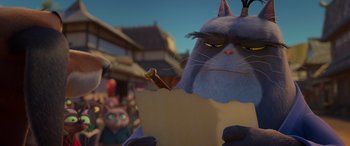 Movie still from “Paws of Fury: The Legend of Hank” (2022), directed by Chris Bailey – A cat is holding a piece of paper; Close Up shot, Over the shoulder angle