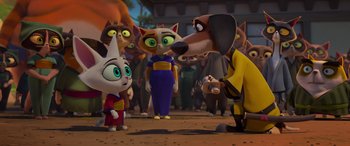 Movie still from “Paws of Fury: The Legend of Hank” (2022), directed by Chris Bailey – A group of people standing next to each other on a dirt ground; Medium shot, Over the shoulder angle