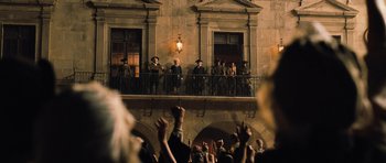Movie still from “Perfume: The Story of a Murderer” (2006), directed by Tom Tykwer – A group of people standing on a balcony; Wide shot, Low angle