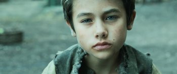 Movie still from “Perfume: The Story of a Murderer” (2006), directed by Tom Tykwer – A young boy's face with blue eyes; Close Up shot, High angle