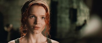 Movie still from “Perfume: The Story of a Murderer” (2006), directed by Tom Tykwer – A person with red hair and green eyes; Close Up shot, Low angle