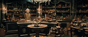 Movie still from “Perfume: The Story of a Murderer” (2006), directed by Tom Tykwer – An antique store filled with lots and lots of stuff; Wide shot, Over the shoulder angle