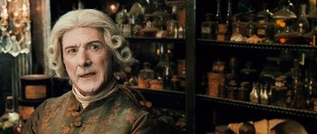 Movie still from “Perfume: The Story of a Murderer” (2006), directed by Tom Tykwer – An older woman with blonde hair and a wig; Close Up shot, Over the shoulder angle