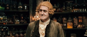 Movie still from “Perfume: The Story of a Murderer” (2006), directed by Tom Tykwer – A person wearing a wig; Medium shot, Low angle