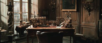 Movie still from “Perfume: The Story of a Murderer” (2006), directed by Tom Tykwer – A table in a room with a lot of candles on it; Extreme Wide shot, High angle