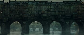 Movie still from “Perfume: The Story of a Murderer” (2006), directed by Tom Tykwer – A painting of a man standing in front of a bridge; Extreme Wide shot, High angle