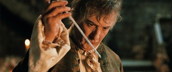 Movie still from “Perfume: The Story of a Murderer” (2006), directed by Tom Tykwer – A person holding a wand; Close Up shot, Low angle