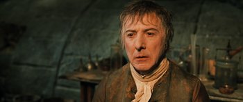 Movie still from “Perfume: The Story of a Murderer” (2006), directed by Tom Tykwer – An older man in a brown and white jacket; Close Up shot, Low angle