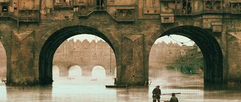 Movie still from “Perfume: The Story of a Murderer” (2006), directed by Tom Tykwer – A man standing on a boat in the middle of a river; Extreme Wide shot, Low angle