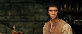 Movie still from “Perfume: The Story of a Murderer” (2006), directed by Tom Tykwer – A young man wearing a brown shirt and a brown vest; Close Up shot, Low angle