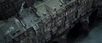 Movie still from “Perfume: The Story of a Murderer” (2006), directed by Tom Tykwer – An aerial view of an old building in the middle of the night; Extreme Wide shot, Overhead angle