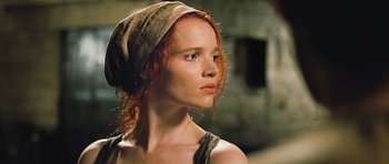 Movie still from “Perfume: The Story of a Murderer” (2006), directed by Tom Tykwer – A woman with red hair wearing a brown hat; Close Up shot, Low angle