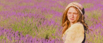 Movie still from “Perfume: The Story of a Murderer” (2006), directed by Tom Tykwer – A woman standing in front of a field of purple flowers; Close Up shot, Low angle