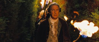 Movie still from “Perfume: The Story of a Murderer” (2006), directed by Tom Tykwer – A man in a brown jacket and a woman in a brown dress; Medium shot, Low angle