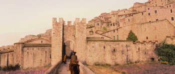 Movie still from “Perfume: The Story of a Murderer” (2006), directed by Tom Tykwer – A man riding a horse down the side of a wall; Extreme Wide shot, Low angle