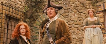 Movie still from “Perfume: The Story of a Murderer” (2006), directed by Tom Tykwer – A man wearing a hat and a jacket; Medium shot, Low angle