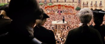 Movie still from “Perfume: The Story of a Murderer” (2006), directed by Tom Tykwer – A crowd of people watching a man on a stage; Extreme Wide shot, High angle