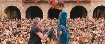 Movie still from “Perfume: The Story of a Murderer” (2006), directed by Tom Tykwer – A man in a blue robe and a man in a black shirt; Wide shot, Low angle