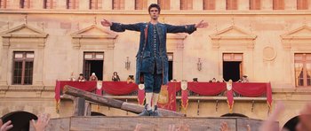 Movie still from “Perfume: The Story of a Murderer” (2006), directed by Tom Tykwer – A man standing on top of a wooden platform; Wide shot, Low angle