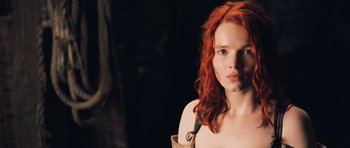 Movie still from “Perfume: The Story of a Murderer” (2006), directed by Tom Tykwer – A beautiful woman with red hair posing for a picture; Close Up shot, Low angle