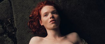 Movie still from “Perfume: The Story of a Murderer” (2006), directed by Tom Tykwer – A woman with red hair laying on the ground; Close Up shot, Overhead angle
